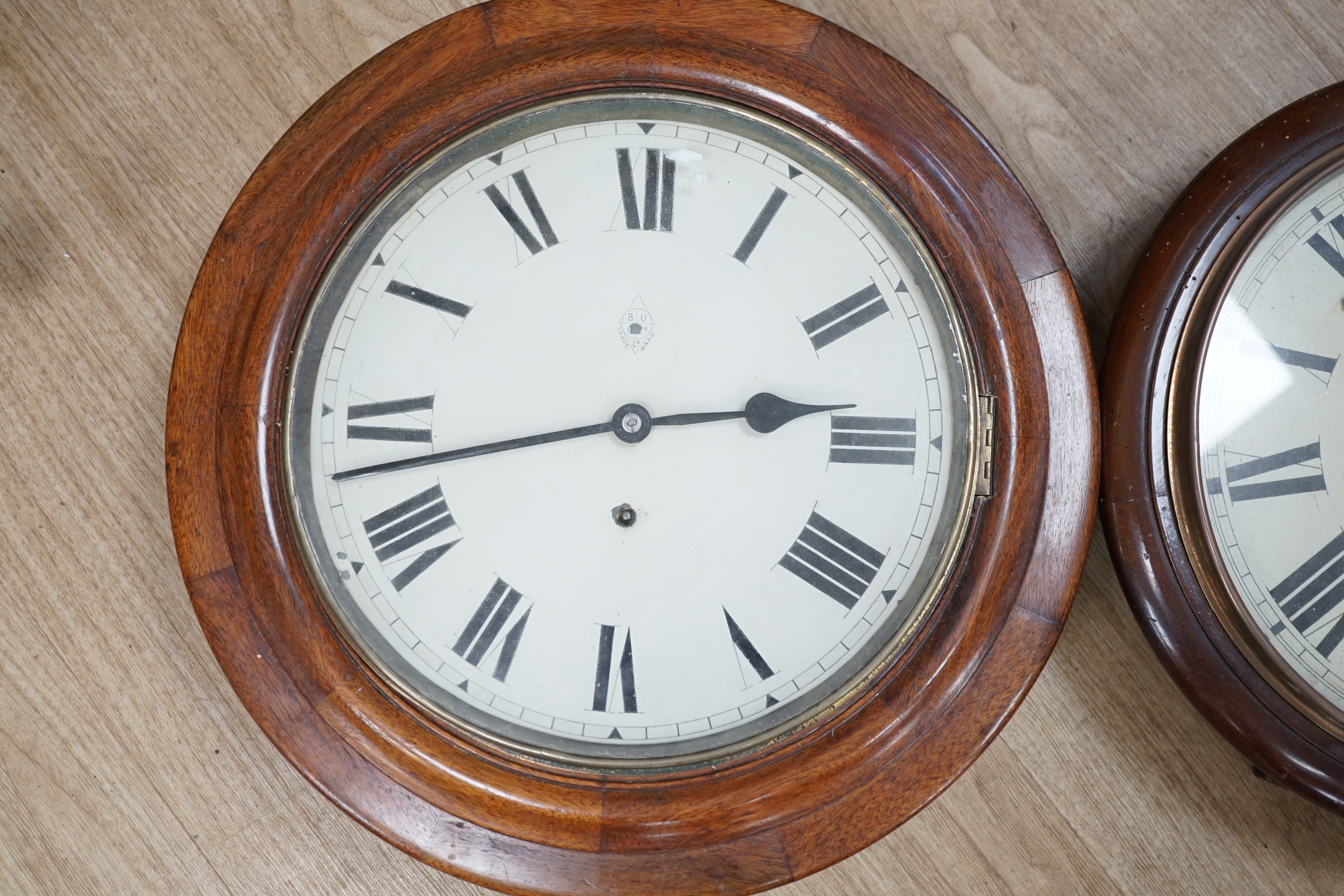 Two early 20th century circular mahogany dial clocks, largest diameter 43cm